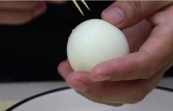第二步,将鸡蛋剥开蛋壳后,用牙签在鸡蛋白上扎上多个小眼,扎的稍微