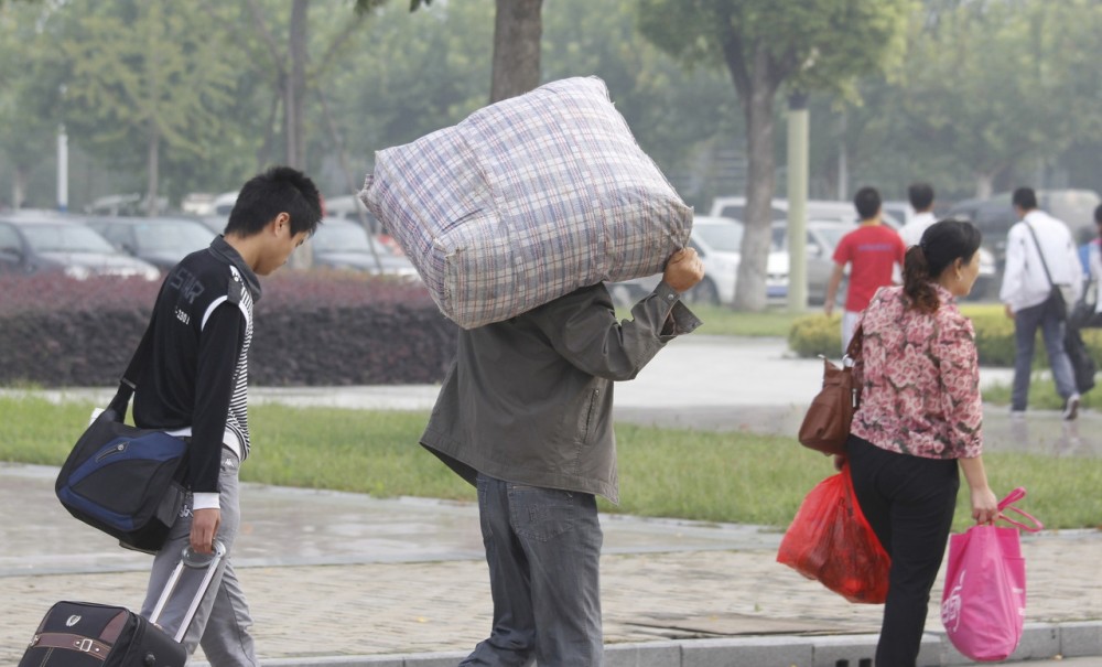 学校要开学了,父母背着沉重的包送孩子上学,背起的还是满满的爱