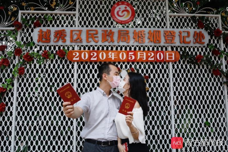 2020年5月20日,广州越秀区民政局婚姻登记处,一对新人拍摄结婚登记本