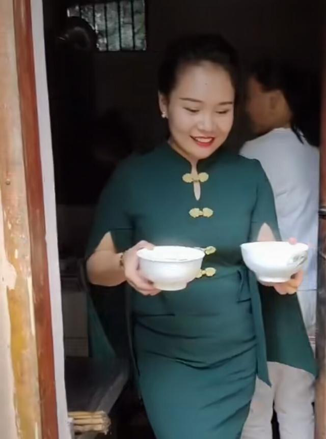 美女袁庆穿得非常漂亮,可还是在那里端碗,并且一个手端一个,和大衣哥