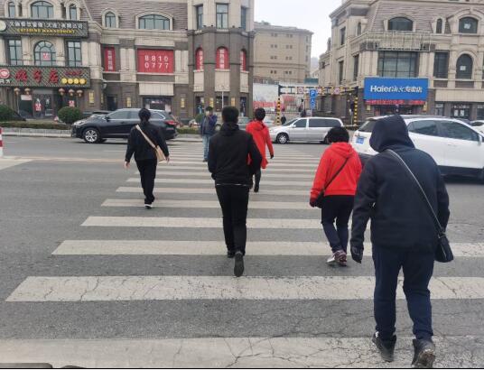 胜利路与万岁街路口,行人过马路在车流中穿行有点难