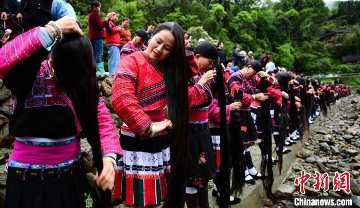 4月14日,在广西桂林龙胜各族自治县龙脊镇黄洛瑶寨,瑶族同胞在河边