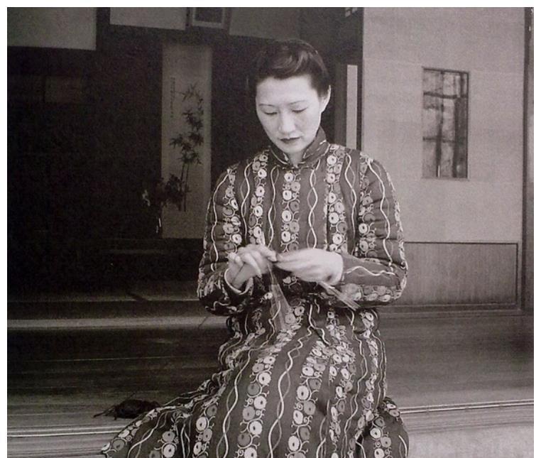 张学良拍摄的赵四小姐在中国台湾照片:在木屋前抽烟,自己动手织毛衣