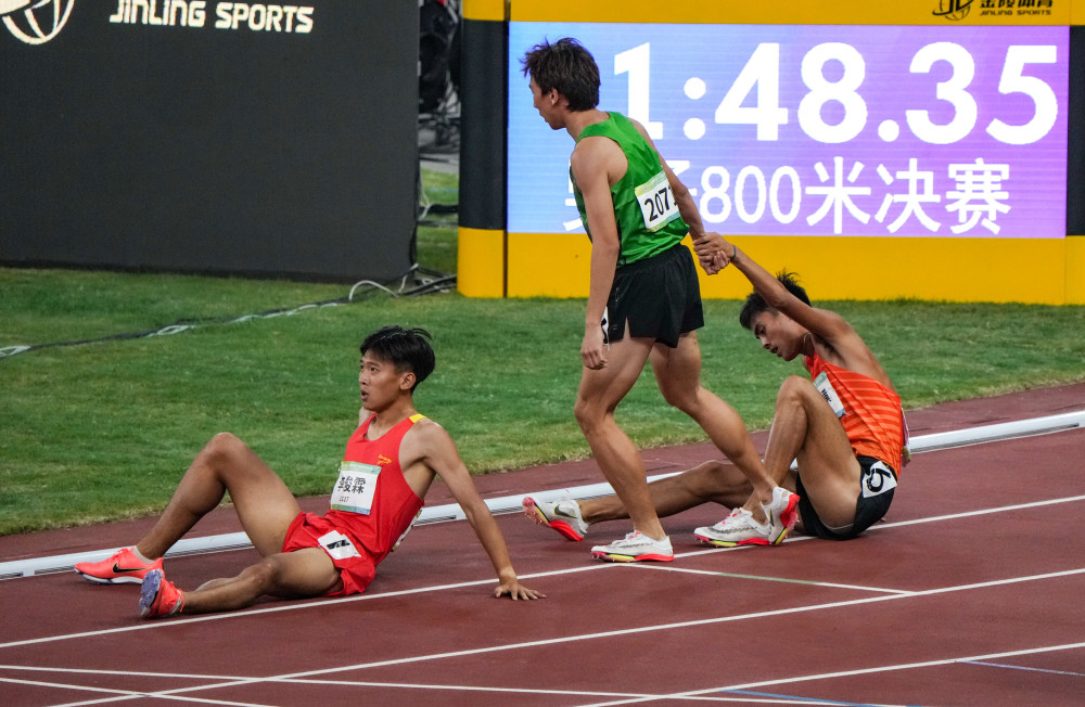 9月22日,甘肃队选手李泽宇(中)拉起浙江队选手奚枭横(右.