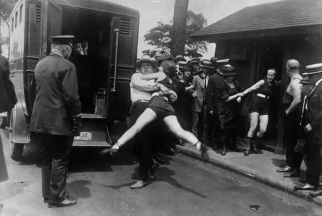 1921年的美国也是很保守的,图为警察在强制带走一位女性,原因是露出
