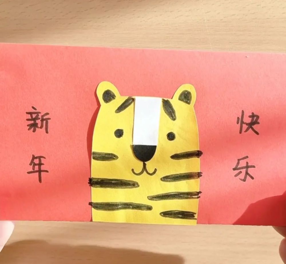 剪一个小老虎的轮廓,粘贴在红包的中间.