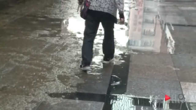 人行道被污水占领 行人通行不便清洁工苦不堪言