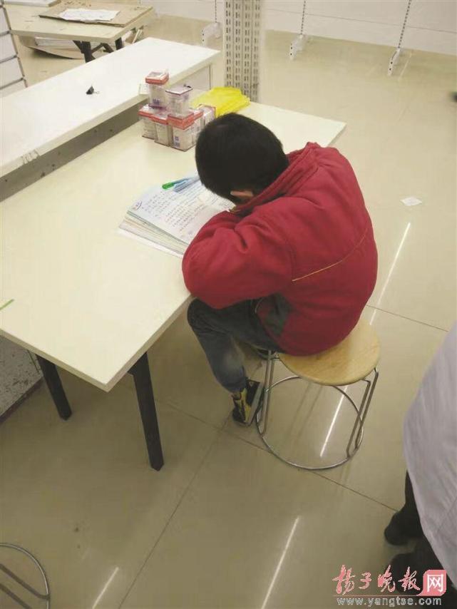 男孩路灯下写作业＂陪＂环卫工妈妈 药店店长好心收留