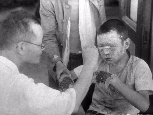 老照片原子弹爆炸后的广岛小男孩背着死去的弟弟等待火化