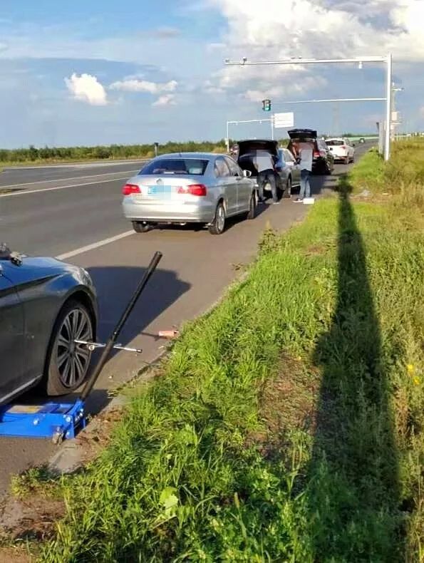 网友轮胎还没换完,后边又一辆宝马7系爆胎停在路边,加入了换胎队伍的