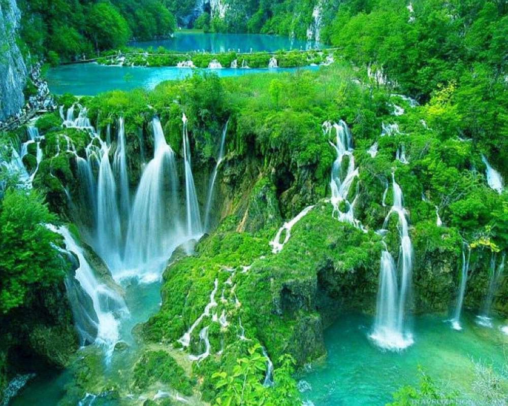 波光粼粼的清澈的水从一个瀑布流到另一个瀑布,风景如画,坐落在