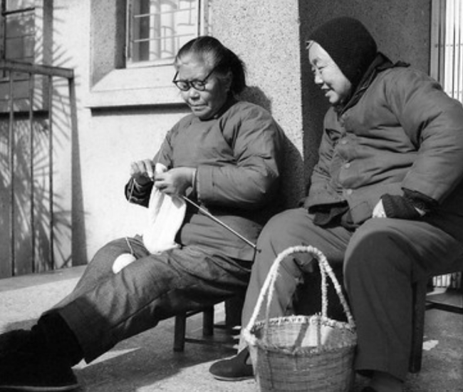 邻居大妈坐在太阳底下织毛衣.