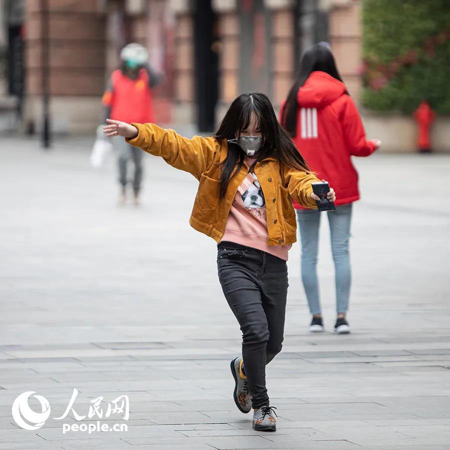 一名少女在步行街上兴奋起舞.陈黎明 摄