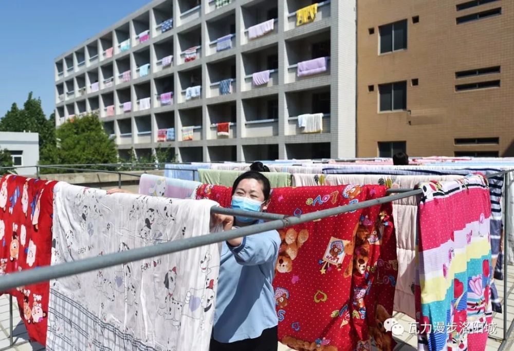 图为2020年5月3日,宿舍工作人员正在晾晒学生被褥.
