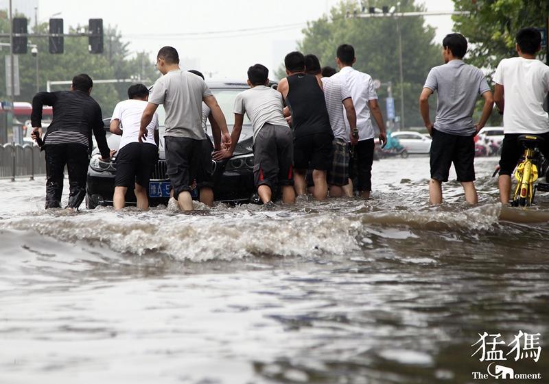 郑州一夜入秋!接连暴雨造成市区严重积水 众人推车忙