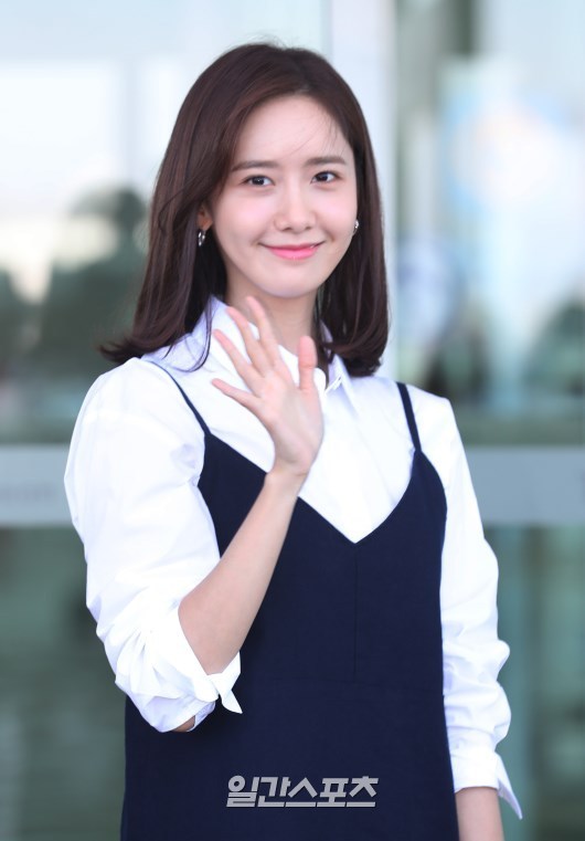 林允儿穿白衬衣搭配吊带裙现身机场笑容甜美,