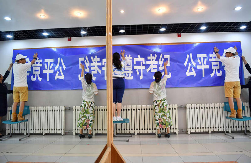 监考老师在考场张贴高考标语.