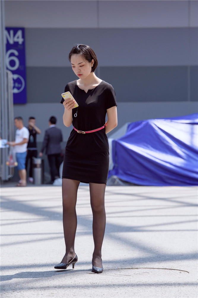 路人街拍:职场女销售现身街头,穿着小黑裙搭配红色腰带,显得很有层次