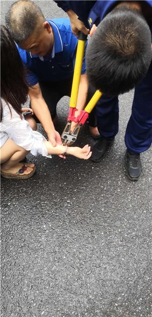 一名双手携带手铐的嫌疑人在两名公安局管教人员的押解下来到消防大队
