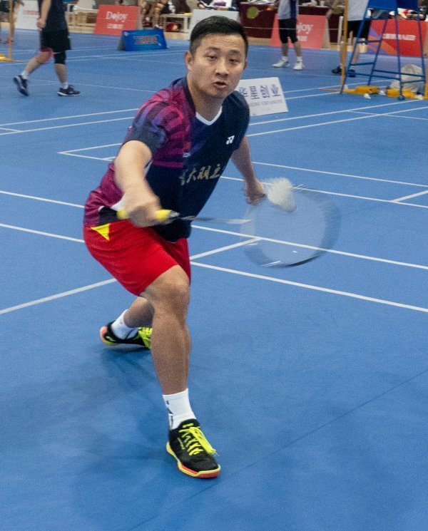 Xu junfeng in action on the badminton court.