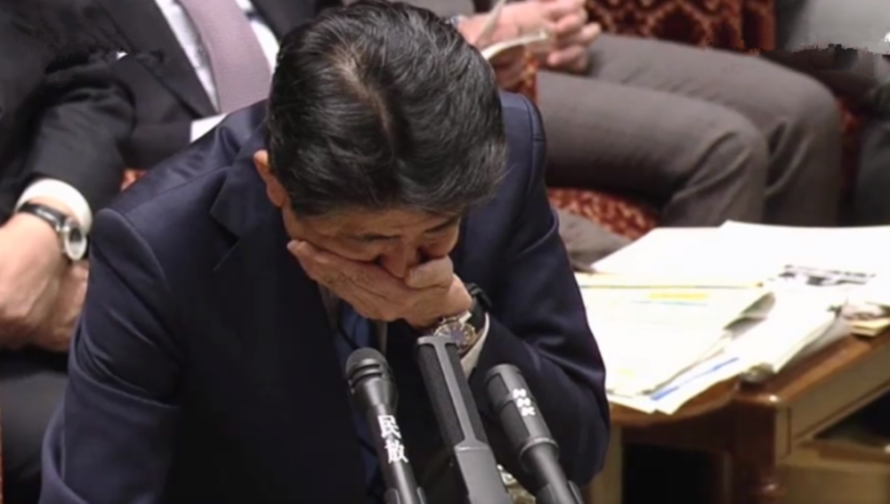 安倍晋三议会发言时捂嘴咳嗽3次,身后两议员的表情和动作亮了
