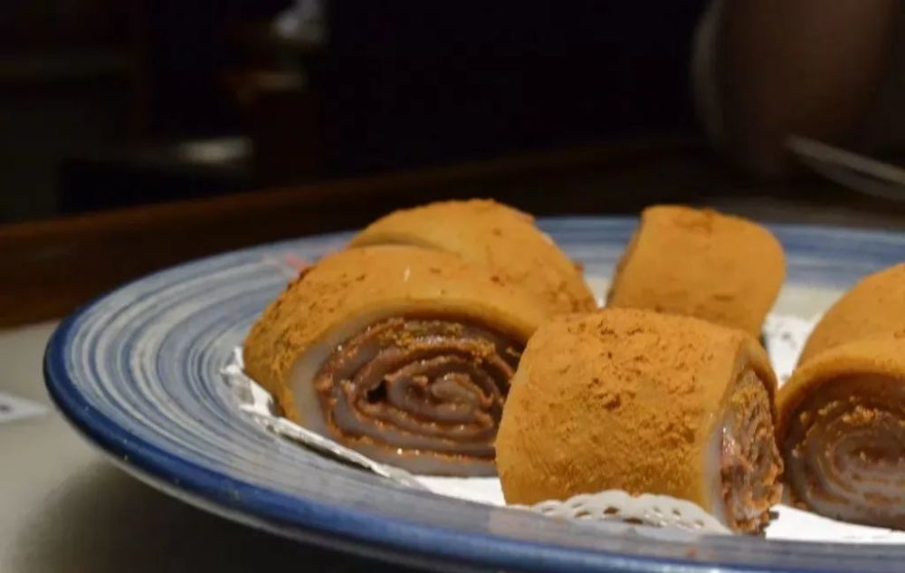 驴打滚儿 驴打滚因其制作工序中撒上的黄豆面, 犹如老北京郊外野驴