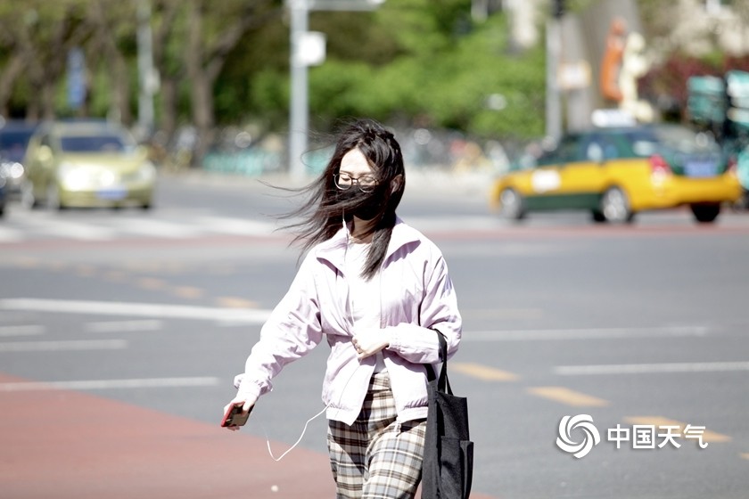 北京街头行人风中"凌乱"