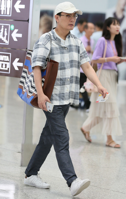 53岁张信哲自信走机场一身休闲好年轻果然男神不老