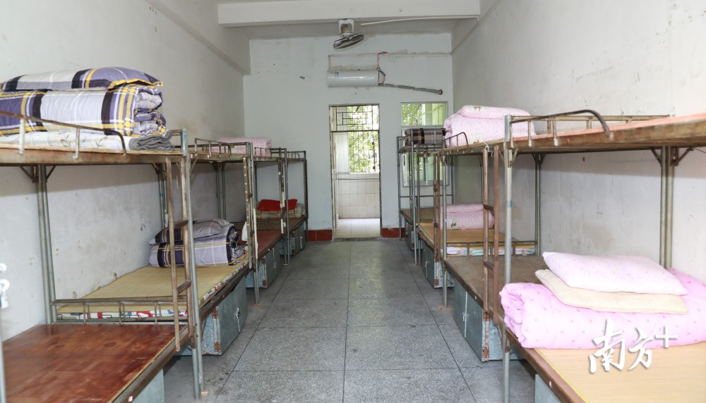 "田家炳中学校长钟竞明7点就在校门口等候学生,手拿麦克风,提醒学生不