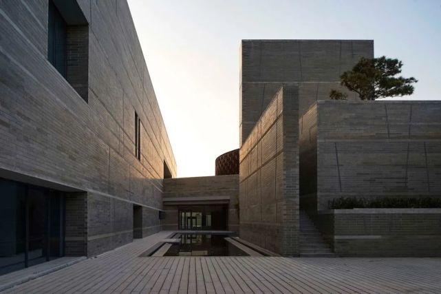 建筑局部 △ 下沉庭院边缘的"清水"片墙 △ "藏起来"的建筑 △ 藏