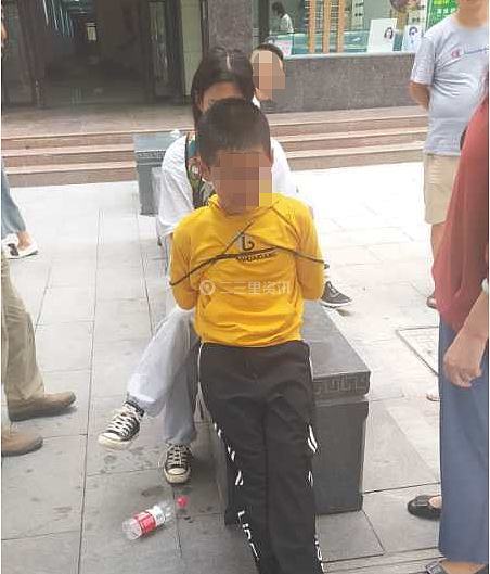 姐姐街头教训弟弟 "五花大绑"遭众人围观