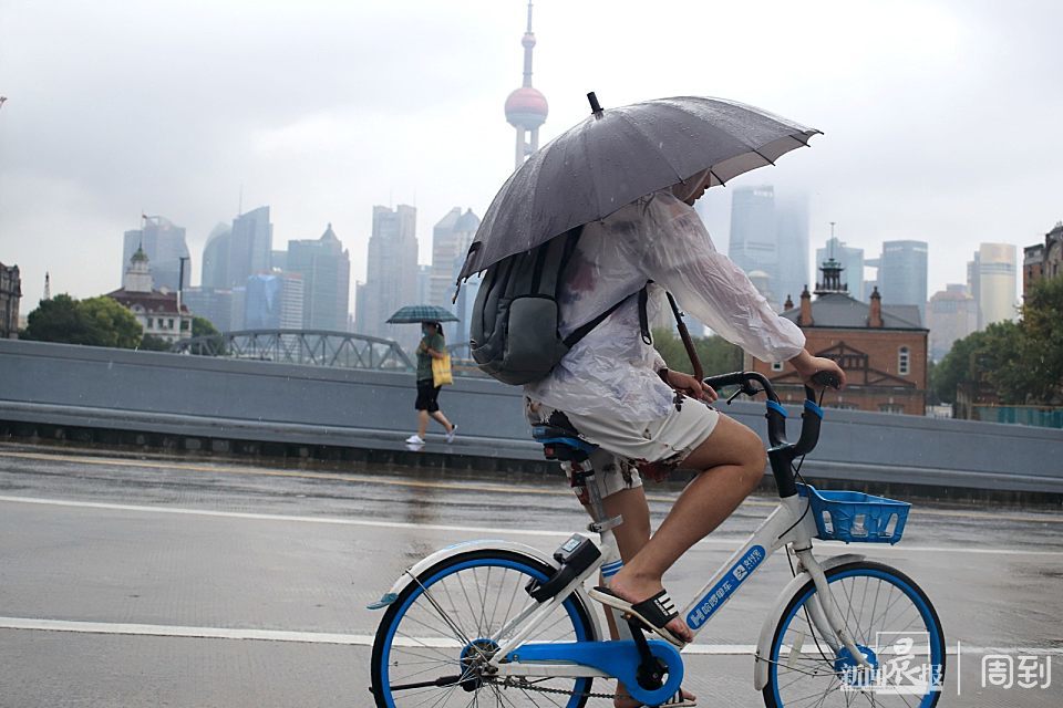 年轻女士雨中撑伞骑车摔倒,切记,撑伞骑车很危险