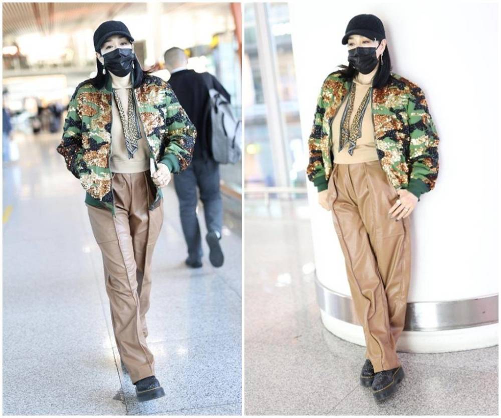 钟丽缇机场造型太尴尬，连帽卫衣配迷彩外套臃肿显壮。