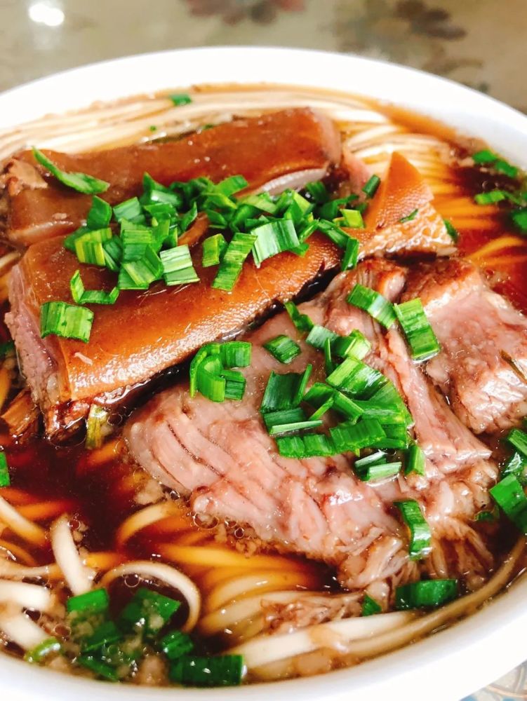 再剪几块红烧羊肉,撒上一把蒜叶,一碗冒着热气的红烧羊肉面就被端上了