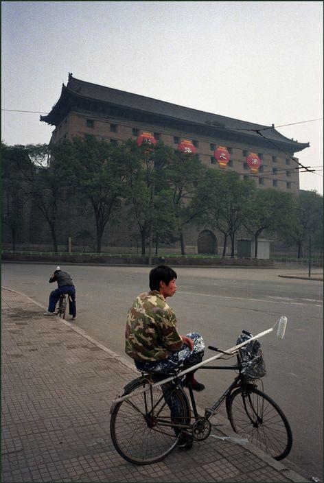 西安街头等雇主上门的民工,不远处就是西安古老的城门.