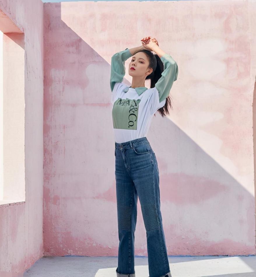 牛仔裤比较修身,很好的勾勒出身材曲线,上面则是选择了蓝色和白色的