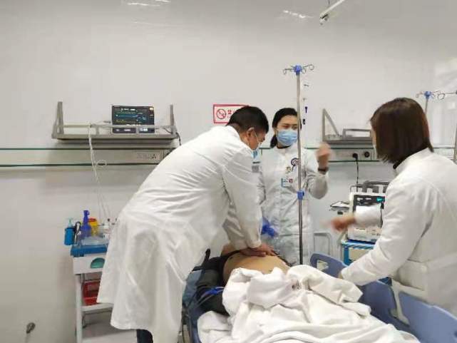 对患者进行持续胸外心脏按压,急救小组赶到现场将患者搬上平板推车后