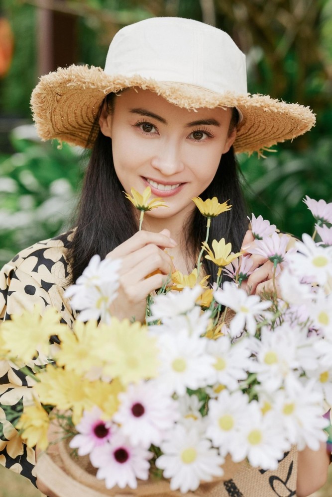 张柏芝晒春游照小雏菊印花衬衫清新减龄配草帽打造田园风