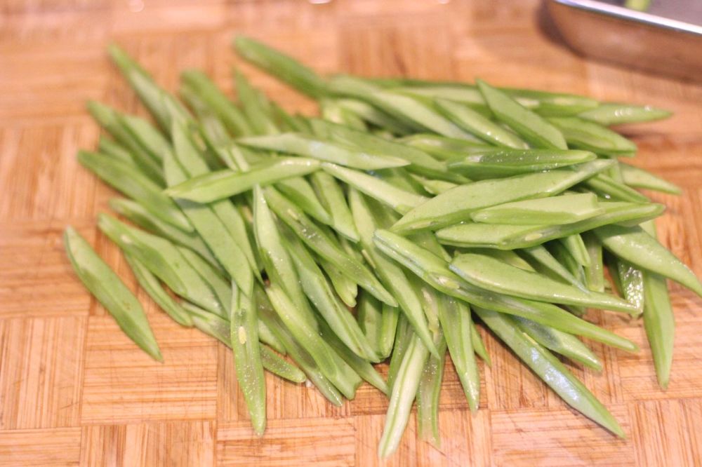 准备好新鲜宽四季豆,宽四季豆要掐掉两头,四季豆撕掉老茎,四季豆用