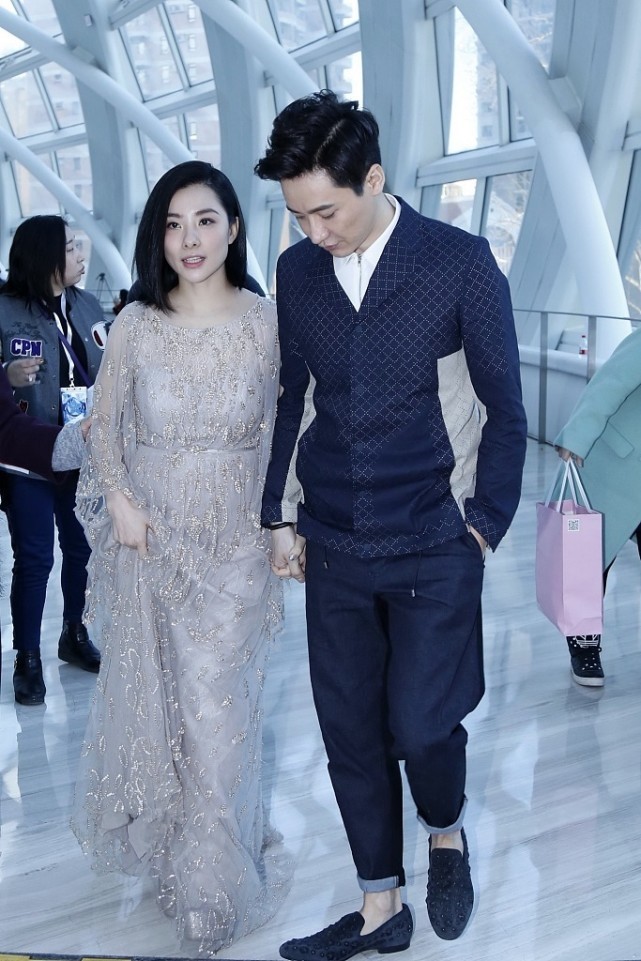 刘璇的裙子有点长,感觉走路都会踩到,但老公在一旁拉着她好体贴
