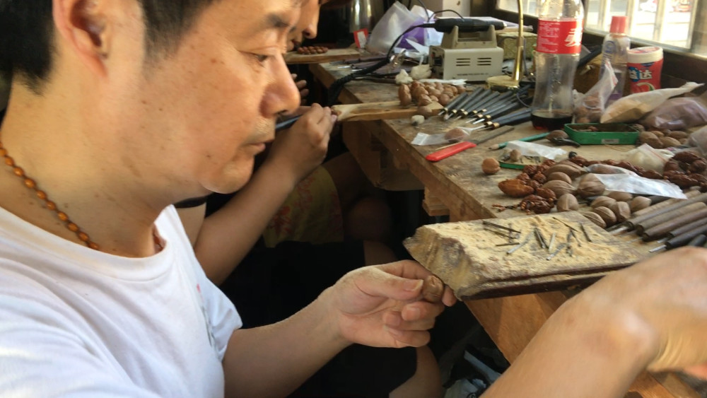 殷根福擅长橄榄核雕,以罗汉头像为独特的代表艺术作品.