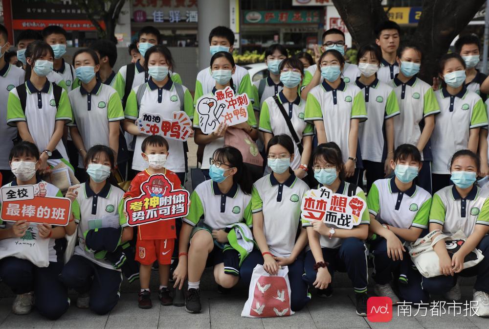 (南都記者 馬強)真光中學白鶴洞本部考點外,家長穿著定製紅衣前來送考