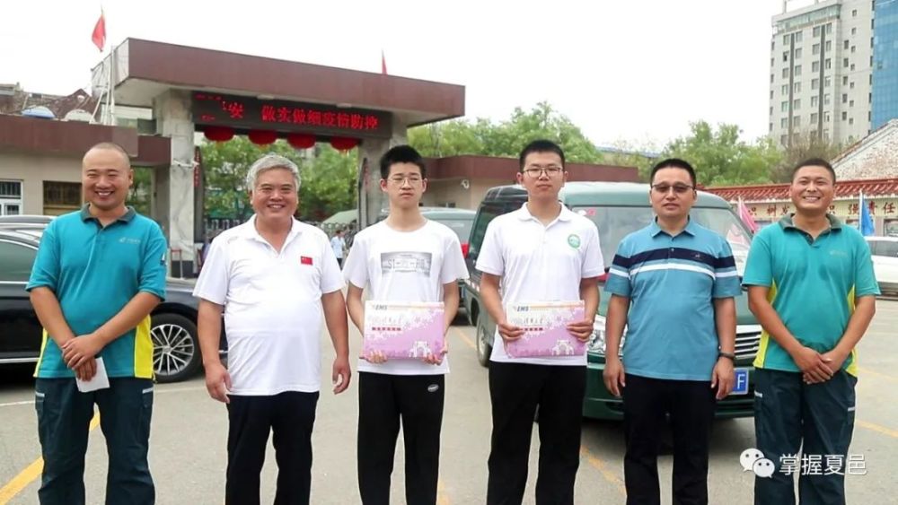 挂着大红绸花的邮政快递车驶进 夏邑县高级中学的校园 常新宇,朱雨辉