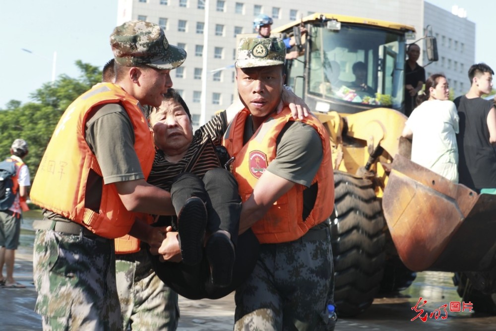 2021年7月26日,抗洪一线官兵在河南省新乡卫辉市紧急转运群众
