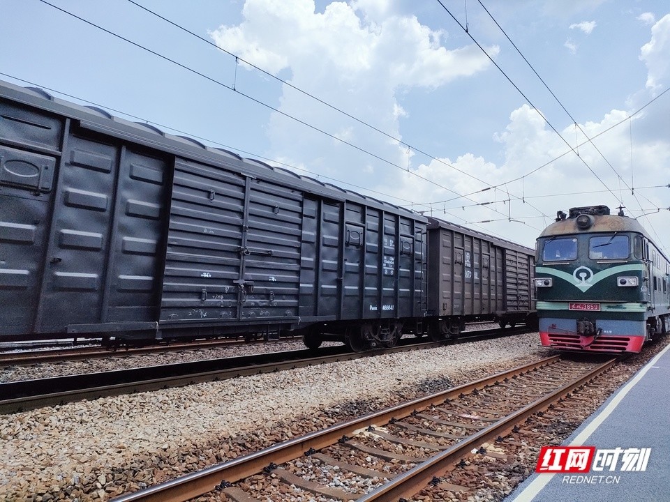 一辆满载货物的货运火车正在经过小站,从湖南出发,驶向广东方向.