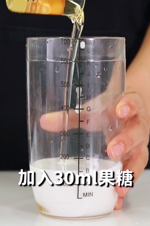 第2步:接着在雪克杯中加入100毫升椰子水,50毫升椰浆,30毫升黄金果糖