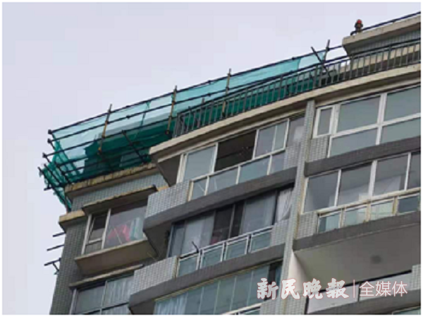 图说:33号居民楼顶楼搭起脚手架 新民晚报记者 徐驰