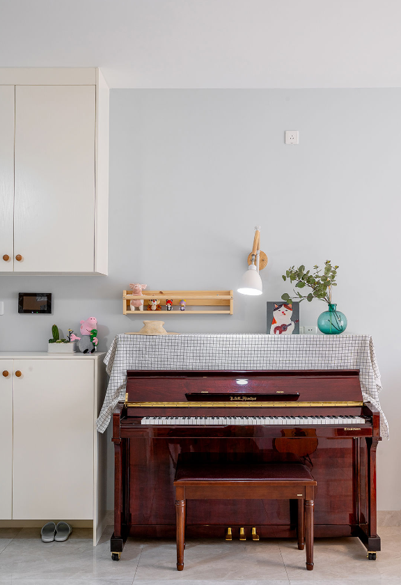 餐厅和客厅之间的入户进门处,玄关柜边上摆上一家钢琴,一进门就会显得
