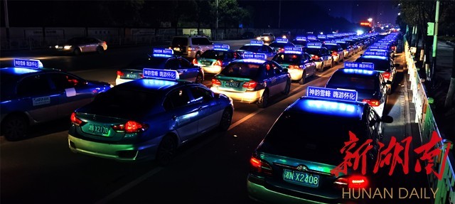 两辆警用摩托车向前开道,同带着"怀化文旅名片"的50台出租车一起向全