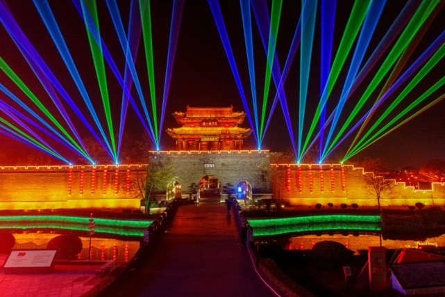 入夜,各种灯笼,亮化设施开启,激光投影同时亮起,还没到古城就远远地